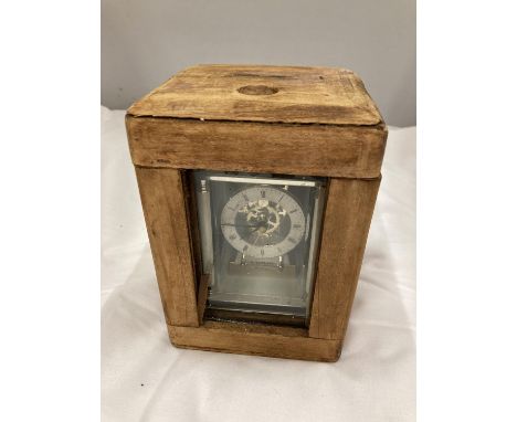 A CARRIAGE CLOCK IN A WOODEN CASE 