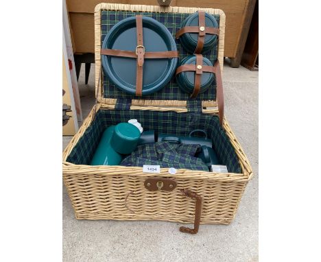 A WICKER PICNIC HAMPER CONTAINING A PICNIC SET 