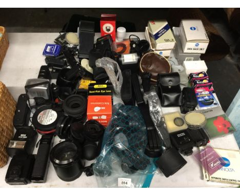 A LARGE COLLECTION OF CAMERA EQUIPMENT TO INCLUDE LENSES, LENS COVERS, FLASHES, LIGHT METER, FILM ETC, BRANDS INCLUDE CANON, 