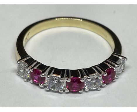 A 9 CARAT GOLD RING WITH THREE RUBYS AND FOUR DIAMONDS ALL IN LINE K/L 