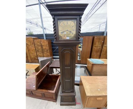 A OAK JACOBEAN STYLE BRASS FACED LONGCASE CLOCK WITH BARLEYTWIST UPRIGHTS 