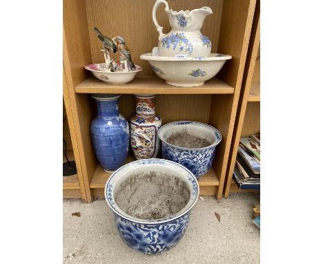 AN ASSORTMENT OF CERAMIC ITEMS TO INCLUDE A JUG AND WASH BOWL, STICK STANDS AND PLANTERS ETC 