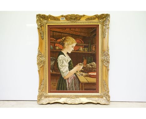 Tapestry panel depicting a young woman in a kitchen, bearing signature and date 1885, 55 x 40cm, gilt framed