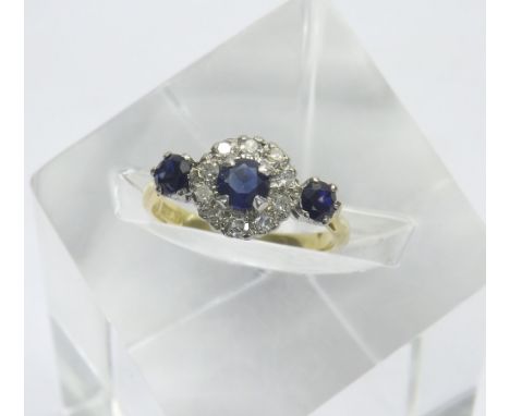 18ct and platinum sapphire and diamond cluster ring, the cluster with a central sapphire in a surround of round-brilliant cut