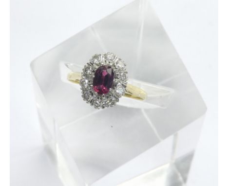 18ct ruby and diamond oval cluster ring, the oval centre stone in a surround of round-brilliant cut diamonds, 3.8gm, ring siz