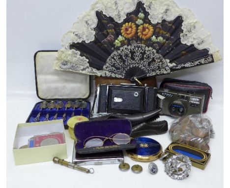 A Zeiss Ikon camera, one other camera, coins including a £5 coin, a Fire Brigade badge and buttons, a Stratton compact, a cig