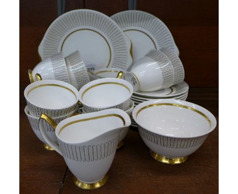 A Royal Albert Capri tea service comprising two cake plates, nine side plates, twelve saucers, nine cups, milk jug and sugar