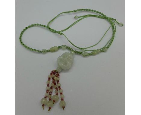 A jade pendant with rope chain