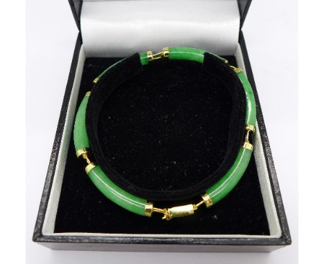 A jade bracelet with silver gilt clasp