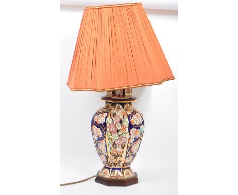A large 20th century ceramic ginger jar style lamp. Having a cobalt blue colouring with gilt detailing and floral designs. Ra
