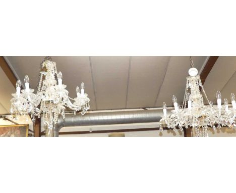 A pair of good quality contemporary cut crystal glass hanging eight-light chandeliers, with typical branch arms and various p