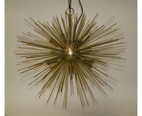 A contemporary gilt brass sunburst hanging ceiling light, having twelve baton lights surrounded by various length rods, raise