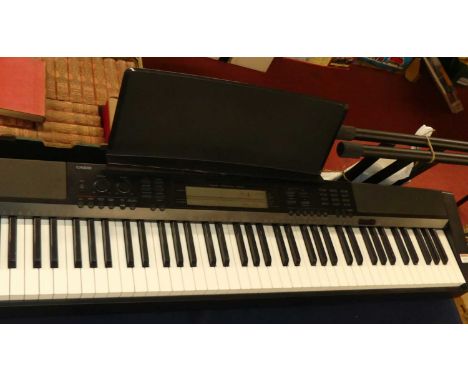 A Casio CDP-200R portable stage piano, raised on folding stand