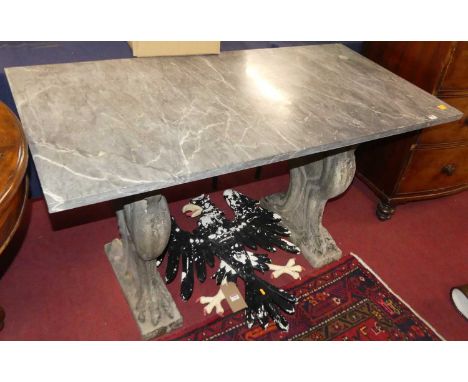 A grey variegated marble topped console table, raised on painted reconstituted stone pedestal end supports, modelled as oppos