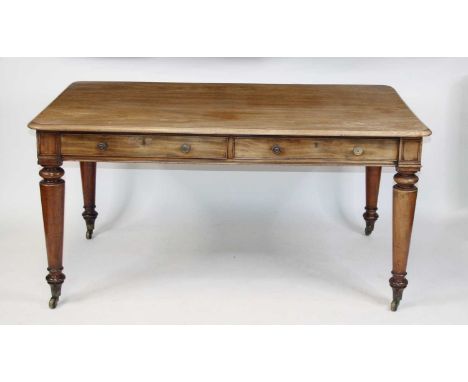 A William IV faded mahogany library table, having alternating real and dummy frieze drawers, raised on ring turned and taperi