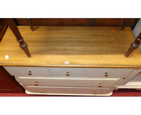 A contemporary light oak and white painted round cornered low chest of drawers, width 121cm