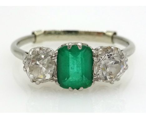 Platinum Ring with a centre oblong cut emerald flanked by two old cut diamonds, each diamond approximately 0.3carat   Conditi