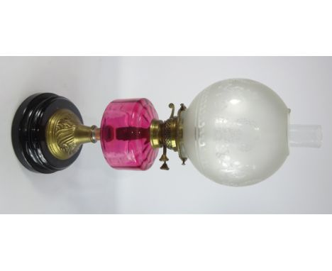 Table Oil Lamp with etched glass shade and cranberry glass reservoir on a circular base, H58cm.    Condition Report & Further