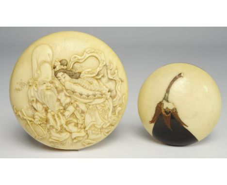 Japanese ivory Kagamibuta Netsuke carved with figures and with further figures and signature to the reverse and a smaller net