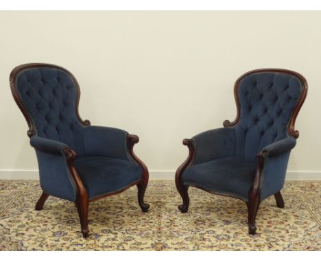 Two Victorian mahogany frame spoon backed Armchairs with buttoned blue upholstery with cabriole supports, to match the previo