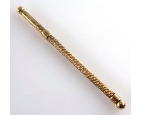 9ct gold Swizzle Stick with engine turned decoration, hallmarked for Birmingham 1950, 10cms long extended.    Condition Repor