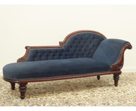 Late Victorian mahogany frame Chaise Longue in blue buttoned upholstery, leaf carved decoration on short turned supports (L18