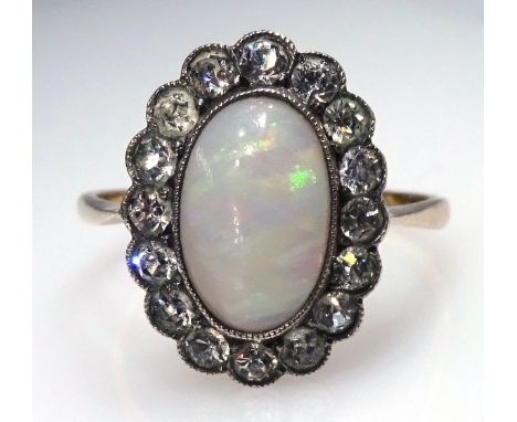 9ct gold Ring set with an oval opal surrounded by diamonds.    Condition Report & Further Details   Click here for further im