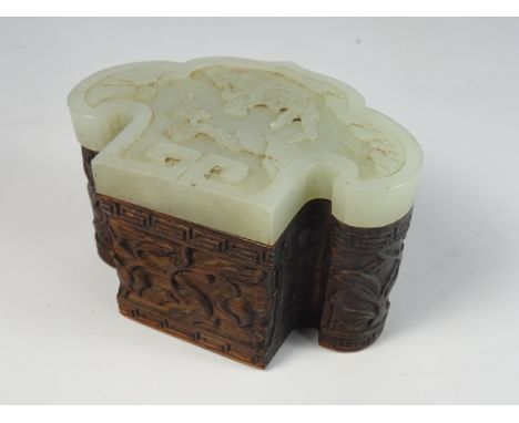 19th / 20th Century Chinese hardwood box with a pale celadon jade Ruyi-form cover carved with a figure in a boat beneath a fl