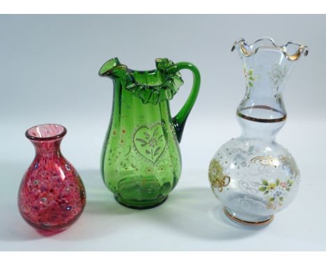 A Victorian green glass jug, an Italian enamelled jug and a red mottled glass vase, tallest 20cm