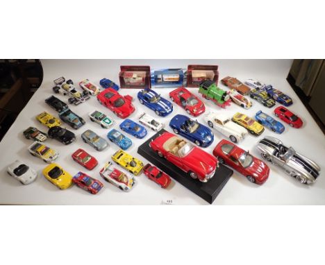 A box of various die cast vehicles including Corgi Kojak Buick Regal, Matchbox Specials racing cars, Burago Dodge Viper etc. 
