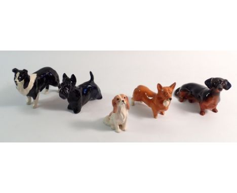Five Beswick dog figures, a seated Spaniel, Corgi, Scottie, Dachsund and Collie, tallest 8cm