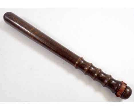 A mahogany truncheon with ribbed handle and impressed mark 106 to base, 38cm long