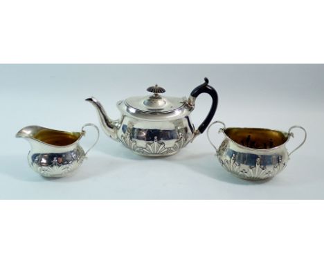A silver three piece bachelors tea set with embossed decoration, London 1903 by William Hutton &amp; Sons Ltd, 430g