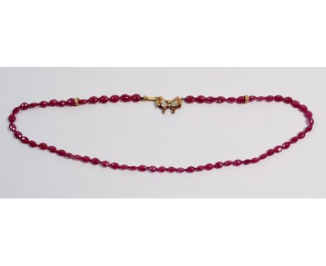 A ruby bead necklace with 9 carat and chip diamond bow clasp, 40cm long