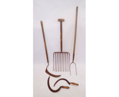 A Victorian hay fork, pitch fork and scythe plus two hand scythes