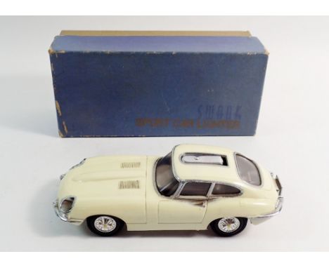 A Swank 1960's E type Jaguar sports car novelty lighter, boxed with original fuel funnel, 15.5cm