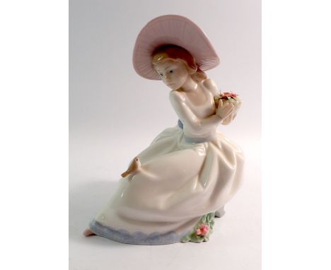 A Nao figure of a girl and bird, 19cm tall