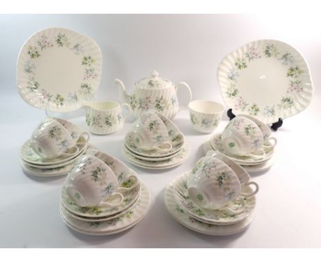 A Minton Spring Valley tea service comprising ten cups and saucers, ten tea plates, teapot, two cake plates, milk and sugar