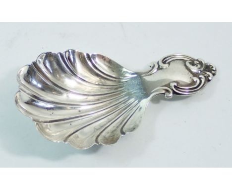 A silver caddy spoon with fluted bowl and scroll handle, Sheffield 1852 by Aaron Hadfield