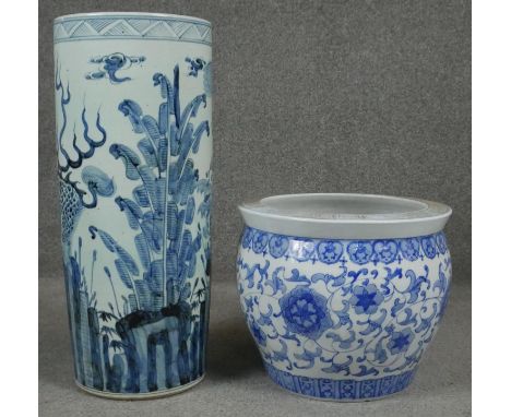 A 20th century Chinese blue and white hand painted umbrella stand decorated with animals and foliage, incised signature to th