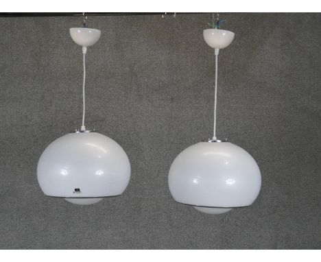 A pair of vintage Guzzini pendant light fittings with maker's labels. 