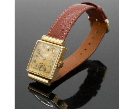 A 14 carat yellow gold vintage mens watch with gold colured dial and black numerals on a brown leather strap. Case stamped 58