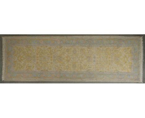 A Tibetan woollen runner with all over floral design. L.316 W.100cm 