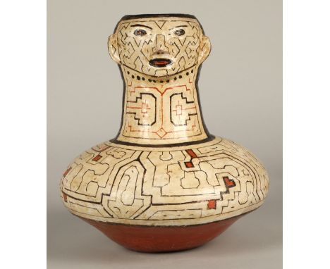 Shipibo terracotta pottery vessel, 20th C, squat base with a tall neck, geometric patterns in brown and red surround a face w
