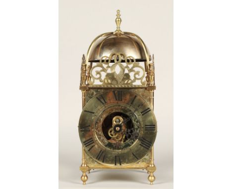 Eureka electric lantern clock, the brass chapter ring enclosing a glazed centre with foliate engraved inner ring signed Eurek