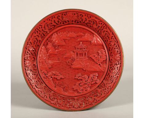 Chinese cinnabar lacquered plate, relief decorated with Chinese garden, 25cm diameter.