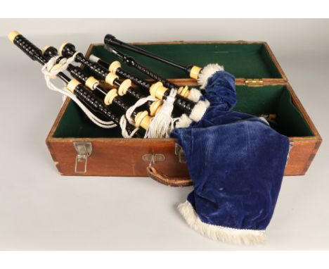 Set of Ivory Mounted bagpipes, unsigned, turned black hardwood with ivory mounts, blue velvet bag in wooden case.Ivory Exempt