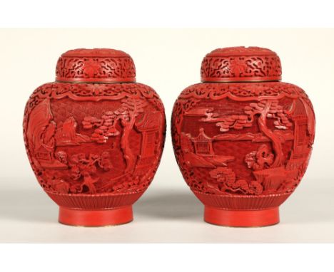 Pair of Chinese cinnabar lacquered ginger jars and covers, relief decorated with Chinese garden, 20cm high.