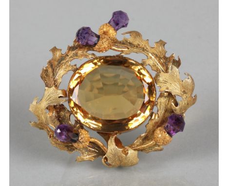 Victorian Scottish brooch with a cairngorm surrounded by sprays of thistles with four amethyst flower heads mounted in yellow
