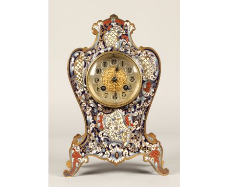 19th Century French Brass Champlevé enamel mantle clock, the silver dial with numerals contained in a waisted case of Rococo 